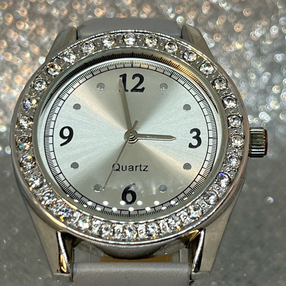 A beautiful silver toned with diamond bezel, and a gray band unbranded watch!